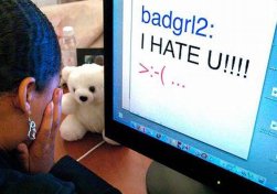 teenager in front of computer with bullying message