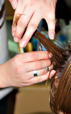 Hairstylist trimming hair