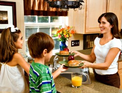 mom serving breakfast to son and daughter