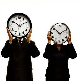 Workers holding clocks in front of their faces