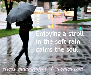 woman strolling in the rain with umbrella