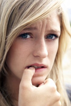 worried teen biting nail