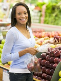 women buying apples at the grocery store