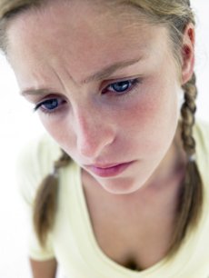 stressed teen with braided hair